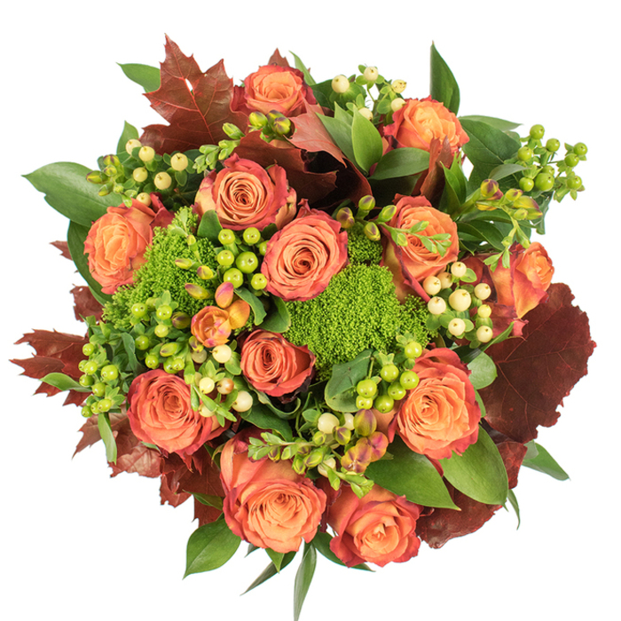 From an overhead viewpoint against a stark white backdrop, this autumnal floral composition feels abundant and warmly composed, echoing the colours of late-season leaves along the River Mole. At its heart are many large, fully opened roses whose petals graduate from a soft, warm orange at the centre to coral-peach and finally to rimmed russet tones, creating a gentle ombré that suggests the turning of the season. Interspersed among these classic roses are clusters of glossy Hypericum berries in both lively lime green and soft, creamy yellow, their small rounded forms offering bright accents and tactile contrast. The arrangement's verdant counterpoint comes from Green Trick dianthus - dense, cushiony spheres of vibrant green that resemble miniature moss mounds, adding both whimsy and grounding texture. Lush, shiny green leaves form the foundational layer, while larger, burnished leaves in deep red-brown and burgundy - similar to fallen oak or maple - are scattered to reinforce the harvest palette and to provide depth and visual weight. The bouquet is lit by a soft, diffuse illumination that brings out the velvet of the petals and the sheen of the foliage without harsh highlights, and the overall scent is suggested as subtly woody and floral. Composed in a compact circular fashion, this piece works beautifully as a seasonal centrepiece for a family gathering, a heartfelt autumn gift, or a cosy addition to an Esher sitting room near the station - a floral echo of autumn walks beside Esher Common and the High Street.